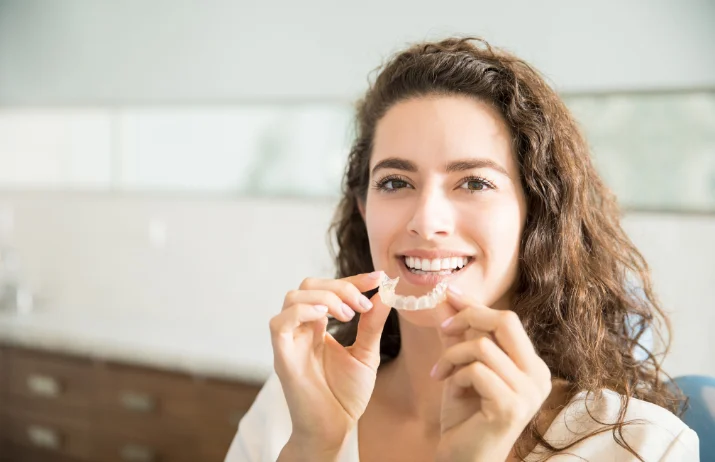 lady holding dental retainers (1)